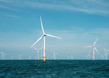 a group of wind turbines in the ocean