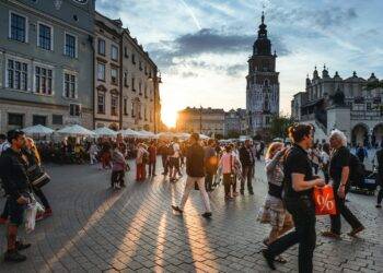 people walking on street near concrete buildings